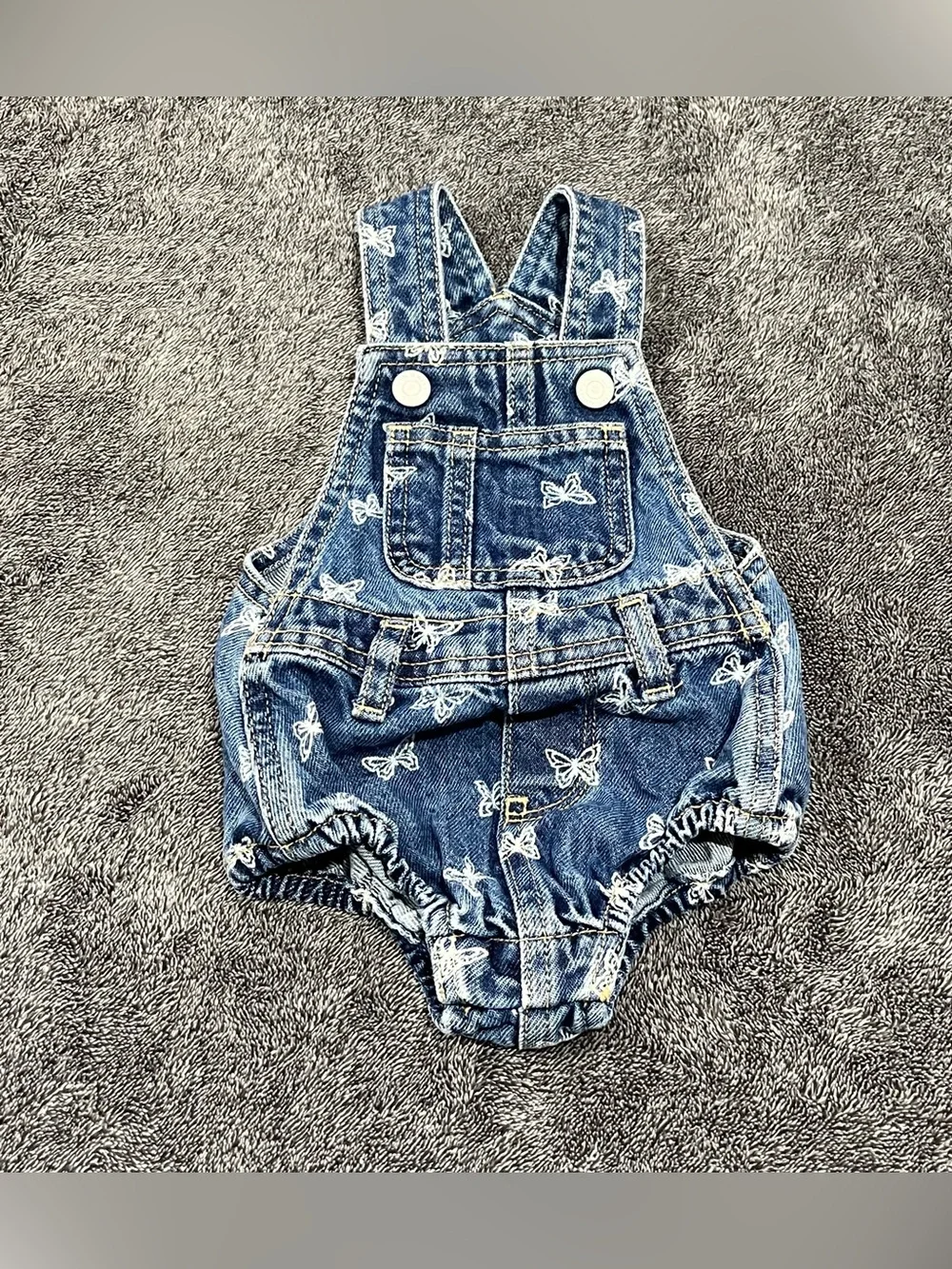 Old Navy jean romper for babies features an all-over white butterfly print 0-3